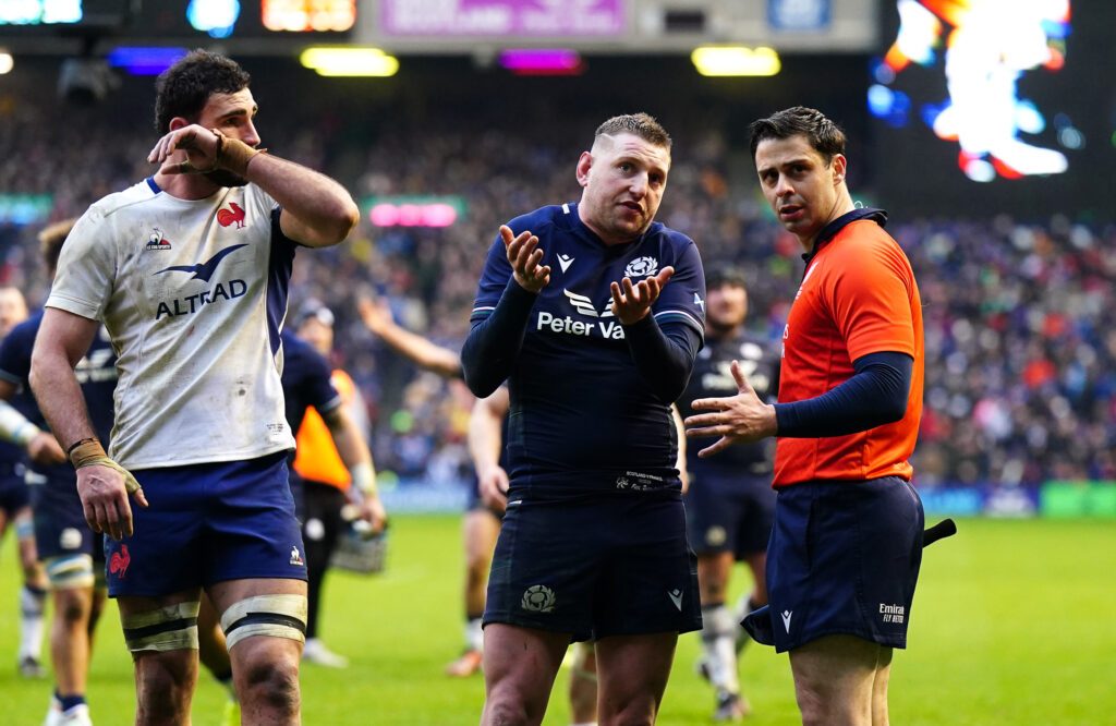 Referee Nika Amashukeli talks to Finn Russell during Scotland v France in the Six Nations