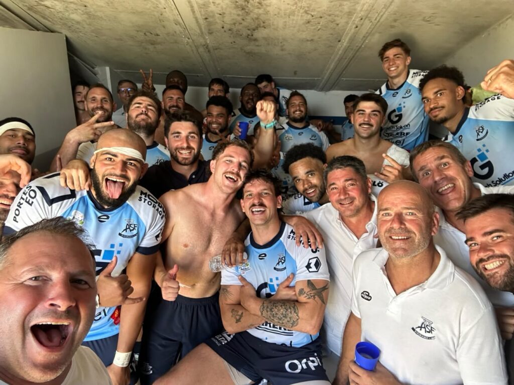 Fleurance players celebrate a win in the changing room in Nationale 2