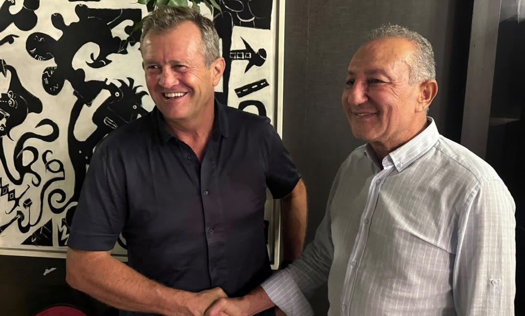 Christophe Hamacek, smiling, shakes hands after his appointment as Tunisia head coach